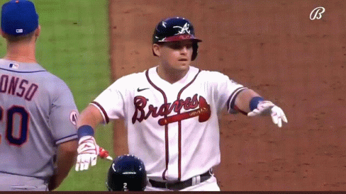 A Baseball Player Wearing A Braves Jersey Stands On The Field GIF