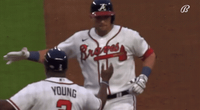 A Baseball Player Wearing A Braves Jersey Talks To Another Player GIF