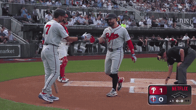 A Baseball Player Wearing A Braves Uniform Is Congratulating Another Player GIF