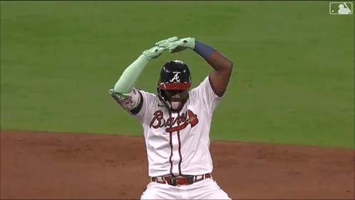 A Baseball Player Wearing A Braves Uniform Is Kneeling On The Field GIF