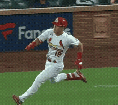 A Baseball Player Wearing A Cardinals Uniform Is Running On A Field . GIF