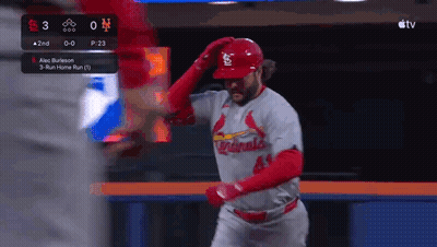 A Baseball Player Wearing A Cardinals Uniform Is Standing In The Outfield . GIF