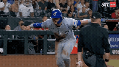 A Baseball Player Wearing A Chicago Cubs Uniform Is Running Towards The Catcher GIF