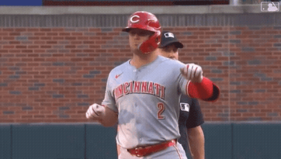 A Baseball Player Wearing A Cincinnati Jersey Is Standing On A Baseball Field . GIF