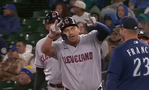 A Baseball Player Wearing A Cleveland Jersey Is Giving A Peace Sign GIF