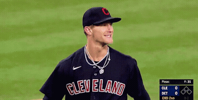 A Baseball Player Wearing A Cleveland Jersey Smiles On The Field GIF