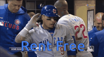 A Baseball Player Wearing A Cubs Jersey Is Being Helped By A Teammate GIF