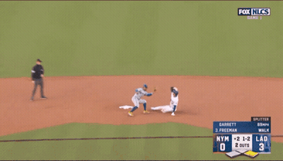 A Baseball Player Wearing A Dodgers Jersey Is Laying On The Ground GIF