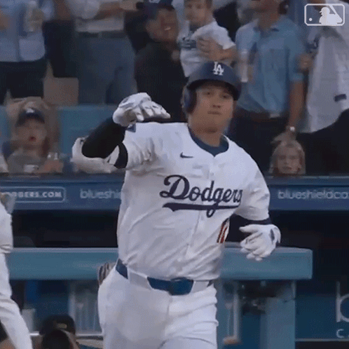 A Baseball Player Wearing A Dodgers Jersey Is Running Towards The Dugout GIF