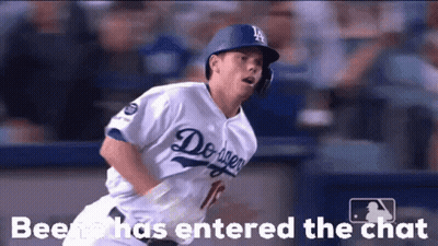 A Baseball Player Wearing A Dodgers Uniform Is Running Towards Home Plate GIF