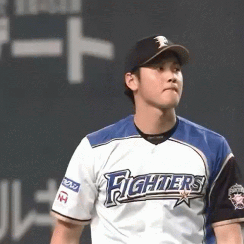 A Baseball Player Wearing A Fighters Jersey Stands On A Field GIF