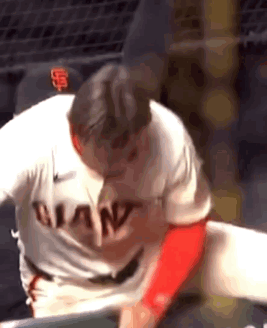 A Baseball Player Wearing A Giants Jersey Is Getting Ready To Throw The Ball . GIF