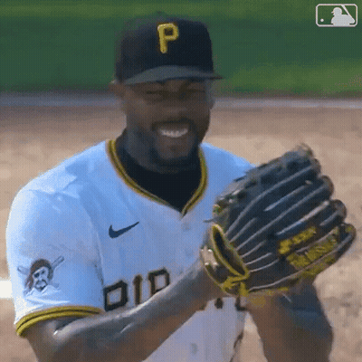A Baseball Player Wearing A Hat With The Letter P On It Is Smiling And Holding A Glove . GIF