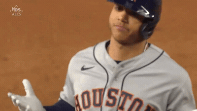 A Baseball Player Wearing A Helmet And A Houston Jersey Is Standing On A Field . GIF