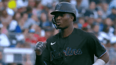 A Baseball Player Wearing A Helmet And A Jersey That Says ' Mariners ' On It . GIF