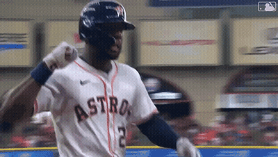 A Baseball Player Wearing A Helmet And A Jersey With The Word Astros On It Is Standing On The Field . GIF
