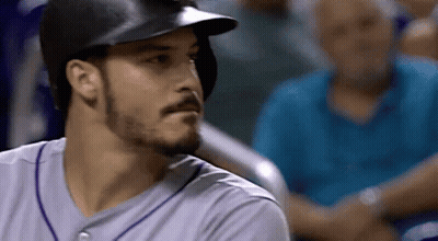 A Baseball Player Wearing A Helmet And A Purple Jersey GIF