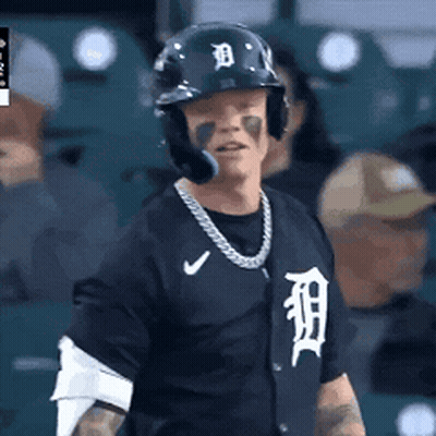 A Baseball Player Wearing A Helmet And A Tigers Jersey GIF