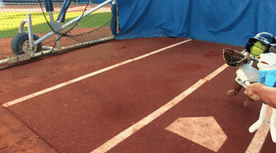 A Baseball Player Wearing A Helmet And Glove Holds A Bat In Front Of A Base GIF