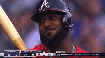 A Baseball Player Wearing A Helmet And Holding A Bat GIF
