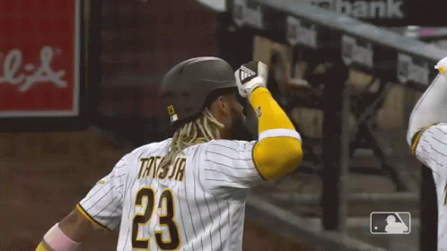 A Baseball Player Wearing A Helmet And Jersey With The Number 23 On It GIF