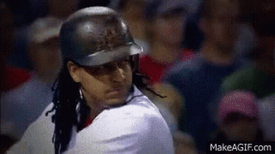 A Baseball Player Wearing A Helmet Is Swinging At A Ball In Front Of A Crowd . GIF