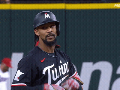 A Baseball Player Wearing A Helmet With A Letter M On It GIF