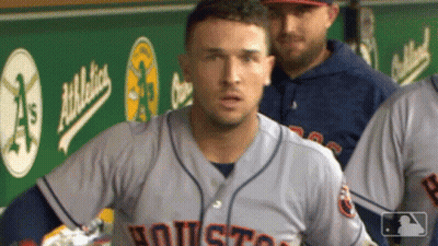 A Baseball Player Wearing A Houston Jersey Stands In The Dugout GIF
