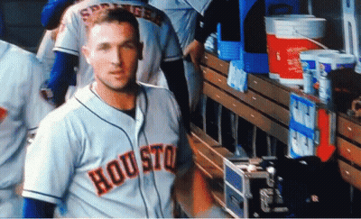 A Baseball Player Wearing A Houston Jersey Stands In The Dugout GIF