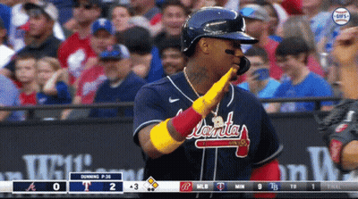 A Baseball Player Wearing A Jersey That Says Atlanta Is Giving A High Five GIF