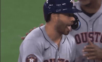 A Baseball Player Wearing A Jersey That Says Houston On The Front GIF