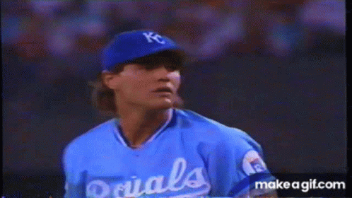 A Baseball Player Wearing A Kc Hat And Glove Is Getting Ready To Throw The Ball GIF