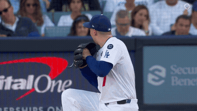 A Baseball Player Wearing A La Jersey Is Kneeling Down On The Field GIF