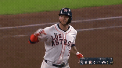 A Baseball Player Wearing A Los Astros Uniform Is Running On The Field GIF