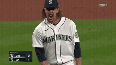A Baseball Player Wearing A Mariners Jersey Stands On The Field GIF