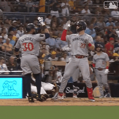 A Baseball Player Wearing A Minnesota Jersey Stands On The Field GIF