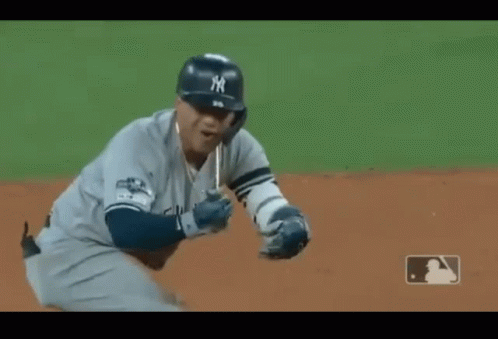 A Baseball Player Wearing A New York Jersey Is Standing On The Field GIF