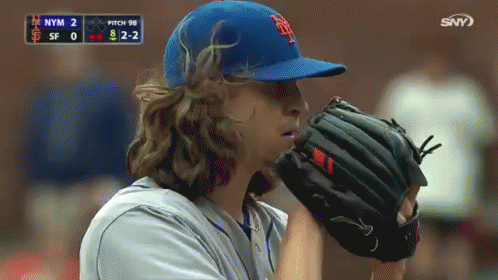 A Baseball Player Wearing A New York Mets Hat And Glove GIF