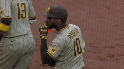 A Baseball Player Wearing A Number 10 Jersey Holds His Finger To His Lips GIF