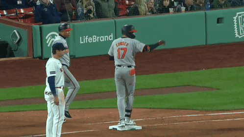A Baseball Player Wearing A Number 17 Jersey Stands On The Base GIF