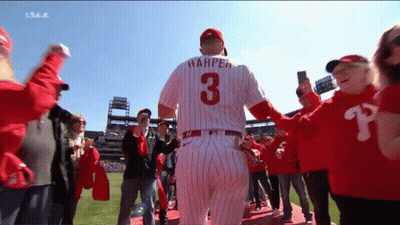 A Baseball Player Wearing A Number 3 Jersey Is Surrounded By Fans GIF