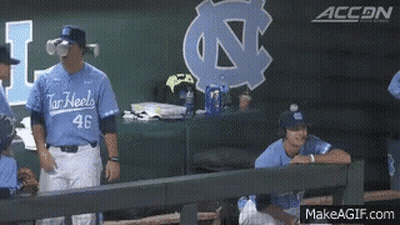A Baseball Player Wearing A Number 46 Jersey Stands In The Dugout GIF