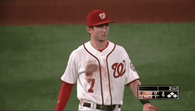 A Baseball Player Wearing A Number 7 Jersey Stands On The Field GIF