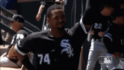 A Baseball Player Wearing A Number 74 Jersey Is Standing On The Field . GIF