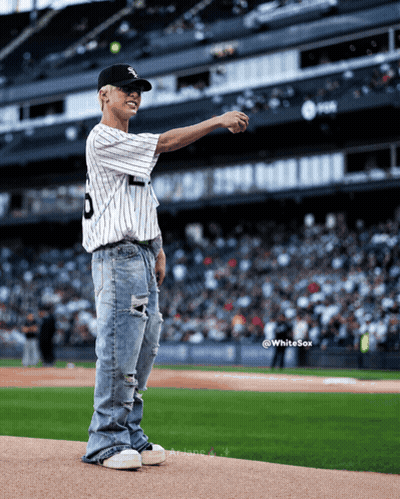 A Baseball Player Wearing A Number 9 Jersey Throws A Ball GIF