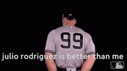 A Baseball Player Wearing A Number 99 Jersey Is Standing In The Dark . GIF