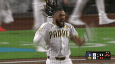 A Baseball Player Wearing A Padres Jersey Is Celebrating On The Field GIF