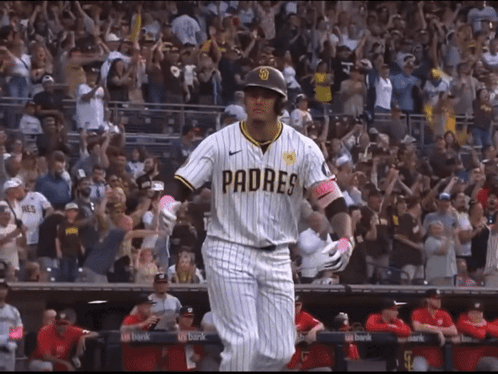 A Baseball Player Wearing A Padres Jersey Is Walking Towards The Dugout GIF