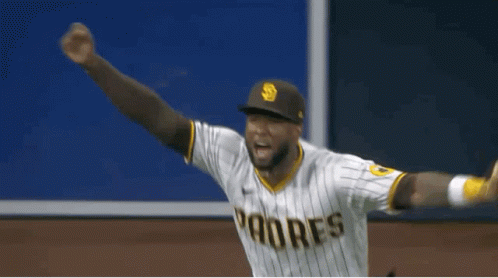 A Baseball Player Wearing A Padres Uniform Is Standing On The Field . GIF