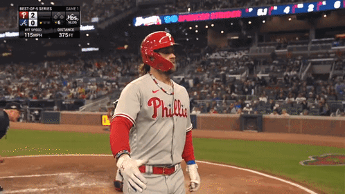 A Baseball Player Wearing A Phillies Jersey Is Standing On The Field GIF
